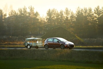 Fototapeta premium Passenger vehicle towing trailer for summer trip
