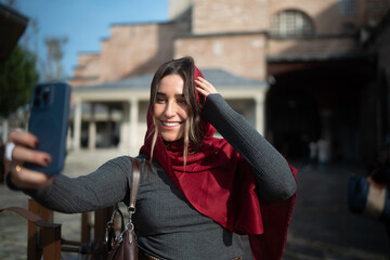 Smiling Traveler Taking a Selfie in a Historic City