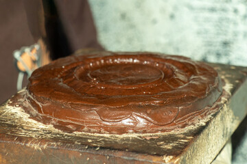 A brown enamel circular, brown tone and glossy texture melting