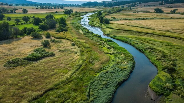 Aerial Drone View of Meandering River Winding Through Vibrant Patchwork Fields
Title (Chinese)