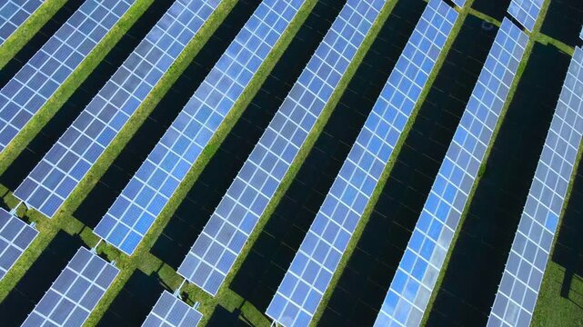 Aerial view of a large solar panel farm generating clean renewable energy, showcasing sustainable power production, green technology, and modern infrastructure for a low-carbon future. 