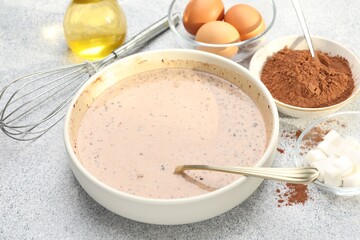 Chocolate dough and ingredients on grey textured table, closeup