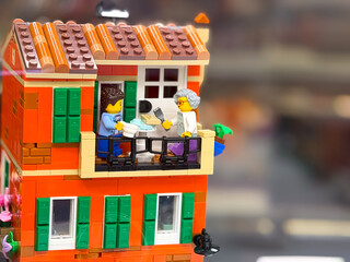 Fototapeta premium Colorful lego building with characters on balcony