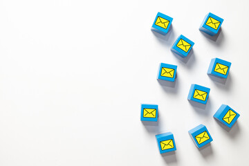 Blue blocks with envelope icons on white background representing email marketing strategy, newsletter distribution, global communication network, spam filtering, and digital messaging system.