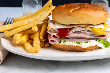 turkey and ham sandwich served with french fries