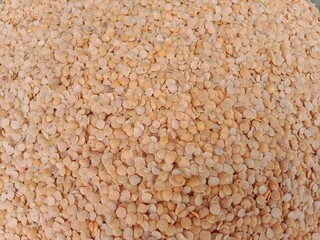Masoor dal pile displayed in order on vendor's.red lentil pile pattern background.Lens culinaris pile pattern 
