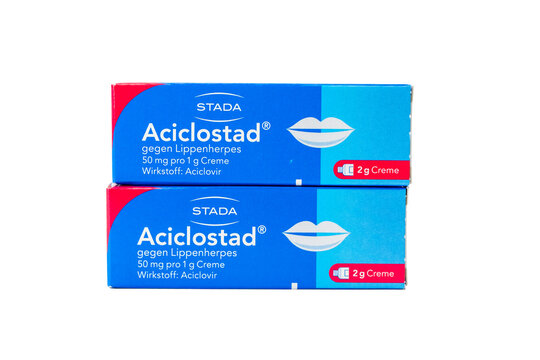 Aciclostad aciclovir cream boxes stacked, isolated on white. Pharmacy packshot for cold sore and herpes treatment themes.