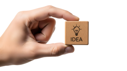 Hand holding a small wooden block featuring a lightbulb icon and the word “IDEA,” symbolizing creativity, innovation, brainstorming, and business inspiration.