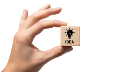 Hand holding a small wooden block featuring a lightbulb icon and the word “IDEA,” symbolizing creativity, innovation, brainstorming, and business inspiration.