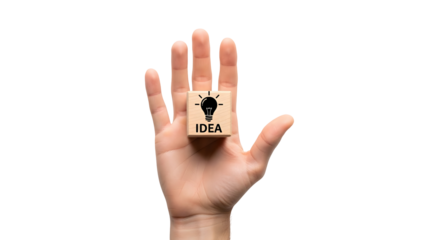 Hand holding a small wooden block featuring a lightbulb icon and the word “IDEA,” symbolizing creativity, innovation, brainstorming, and business inspiration.
