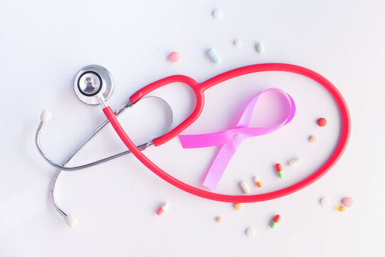  pink ribbon, pills and stethoscope on white background. - Powered by Adobe