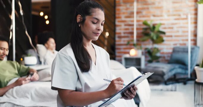 Nurse, woman and writing in clinic with clipboard, wellness medicine and planning patient treatment. Healthcare worker, person and notes with checklist in iv bar for natural drugs, admin and review.