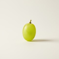 A Single Vibrant Green Grape Standing Alone on a Pale Background