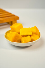 Potrait of some slice of mango fruit inside a small dish. Healthy eating concept