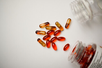 Prescription capsules spilling from the containers. Medical treatment pills. Healthcare and medical concept