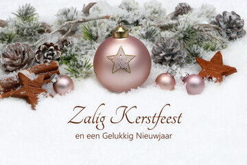 Kerstkaart: Nederlandse kerstgroet met kerstversiering, kerstballen en dennentakken in de sneeuw. Fijne kerst en een gelukkig nieuwjaar. © Racamani
