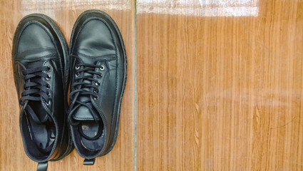 A pair of safety shoes on brown ceramic with a copy space.