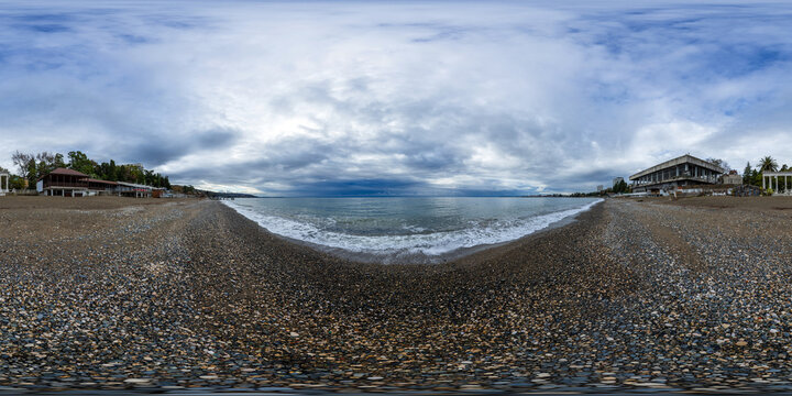 A seamless spherical HDRI panorama, a 360-degree view of a sandy beach by the sea on a cloudy summer day with beautiful clouds in equirectangular projection, VR content. Sea beach panorama.