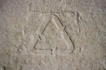 Natural brown paper pulp packaging texture featuring the universal recycling code 21, symbolizing environmental consciousness, sustainability, and responsible consumption.