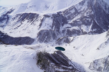 A snow-covered mountain range in the Caucasus region near the Gudauri ski resort. Georgia. Snow-capped mountain peaks and steep slopes.