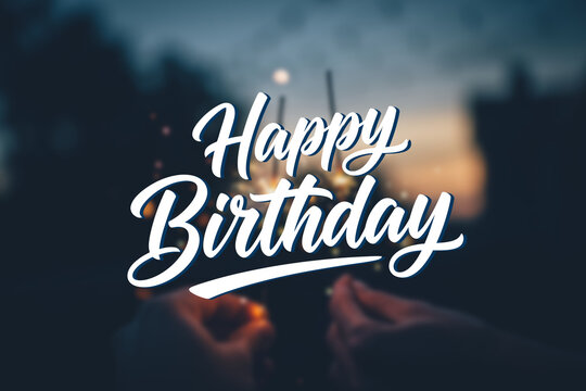 Happy Birthday hand lettering typography in elegant calligraphy style. Birthday greeting text over blurred background with warm bokeh lights, perfect for birthday cards, invitations, posters, social m