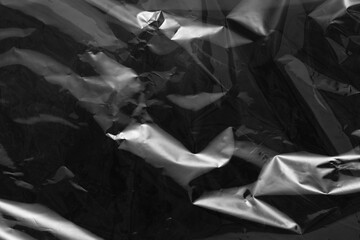 plastic overlay texture of realistic crumpled transparent plastic film wrap on black background,wrinkled stretched plastic effect.abstract plastic background on transparent png