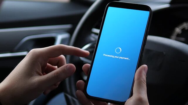 A man uses his smartphone to pay taxes online while sitting in his parked car. The closeup shot follows his actions from reviewing the payment details to securely completing the transaction via