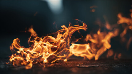 Close-up of vibrant orange flames dancing and flickering against a dark background. Intense fire with swirling patterns and glowing embers creates a dramatic and energetic visual effect.
