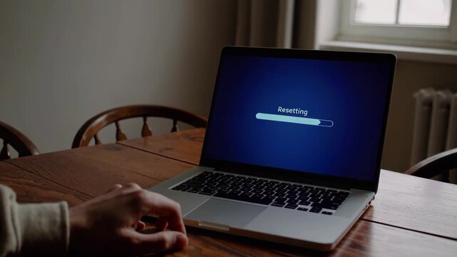 Person Resetting Laptop at Home