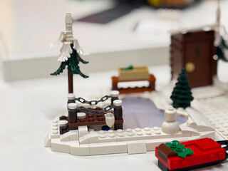 Fototapeta premium Winter-themed lego scene with snowman and frozen pond