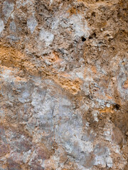 High-resolution close-up of natural soil and sand ground texture. This earthy background shows a rough, granular surface with organic tones,