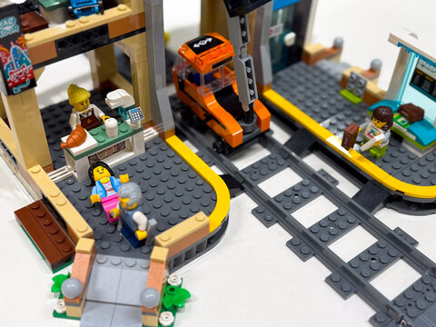 Colorful lego city scene with train station and cafe