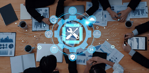 A group of professionals engages in a collaborative meeting, analyzing data through digital tools and visual graphics, aiming to enhance business strategies and outcomes. Trope