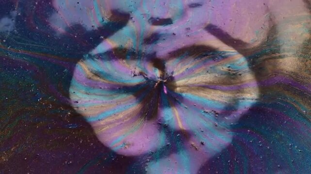 Iridescent oil slick surface texture in motion creating beautiful abstract patterns background  in