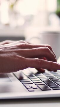 Close-up hands typing an e-mail on a keyboard or working remote
