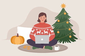 A woman in a festive sweater is working on her laptop surrounded by holiday elements, including a beautifully decorated Christmas tree and delicious cookies, exuding cozy winter vibes.