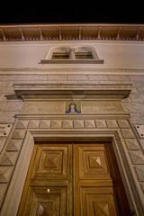Historic Italian street at night with illuminated buildings