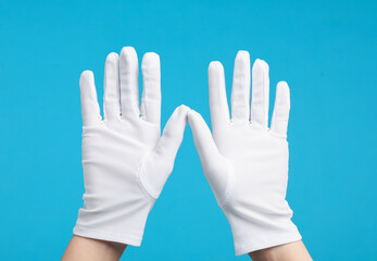 Woman in cloth gloves on light blue background, closeup