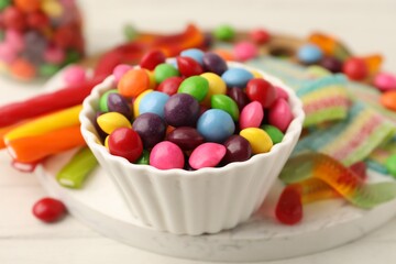 Delicious colorful candies on white table, closeup