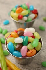 Delicious colorful candies on grey table, closeup