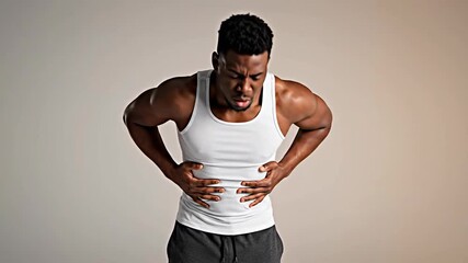 Young Man Experiencing Intense Chest Pain in Studio Shots for Health and Wellness Concept