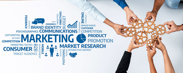 Diverse hands collaborate to symbolize teamwork in marketing strategies, emphasizing brand growth,...