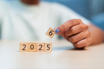 Upcoming milestone child holding block number 6 for 2025 indoor setting focus growth