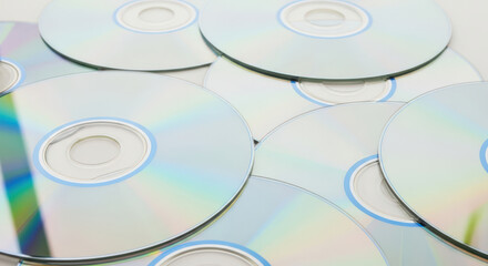 A Stack of Shiny Compact Discs (CDs) Reflecting Light, Showcasing Data Storage Technology and the Evolution of Media in the Digital Age with a Clean Background