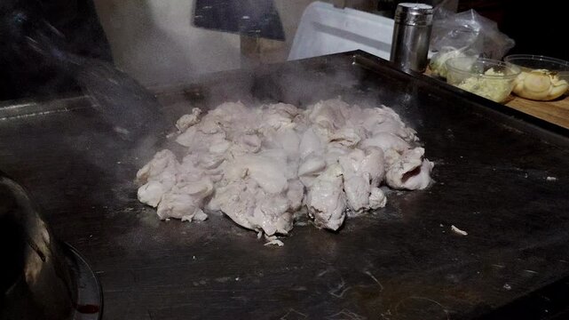 japanese grilled meat on pan. chef cooking at the hot table 