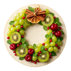 Christmas Fruit Wreath Flat Lay &ndash; Kiwi, Grapes, Pomegranate, and Mint on White Plate
