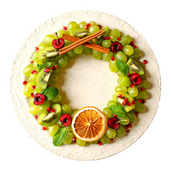 Christmas Fruit Wreath Flat Lay &ndash; Kiwi, Grapes, Pomegranate, and Mint on White Plate
