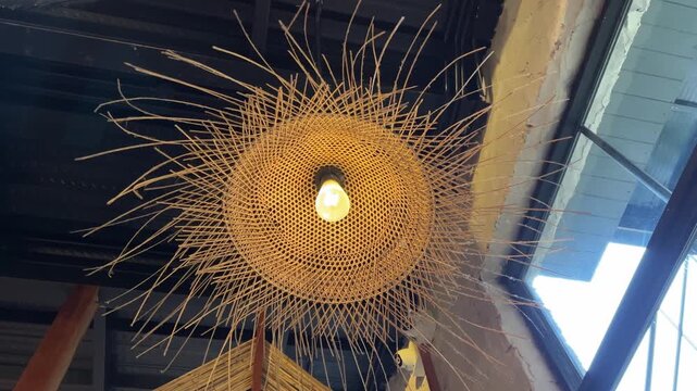 Rattan light fixture hanging rattan pendant lights with plants in warm airy space