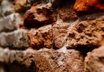 Close-up of rustic weathered brick wall with varied textures and colors