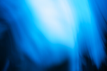 Light streaks create soft abstract pattern in shades of blue and purple. Blurred gradient forms gentle flowing motion reminiscent of fiber connections.